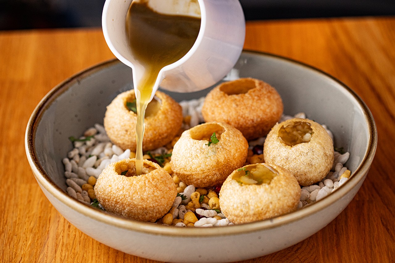 Black Salt's pani puri, or crispy fried puffs filled with seasoned potato, chickpeas, shallots and tamarind-mint flavored water.