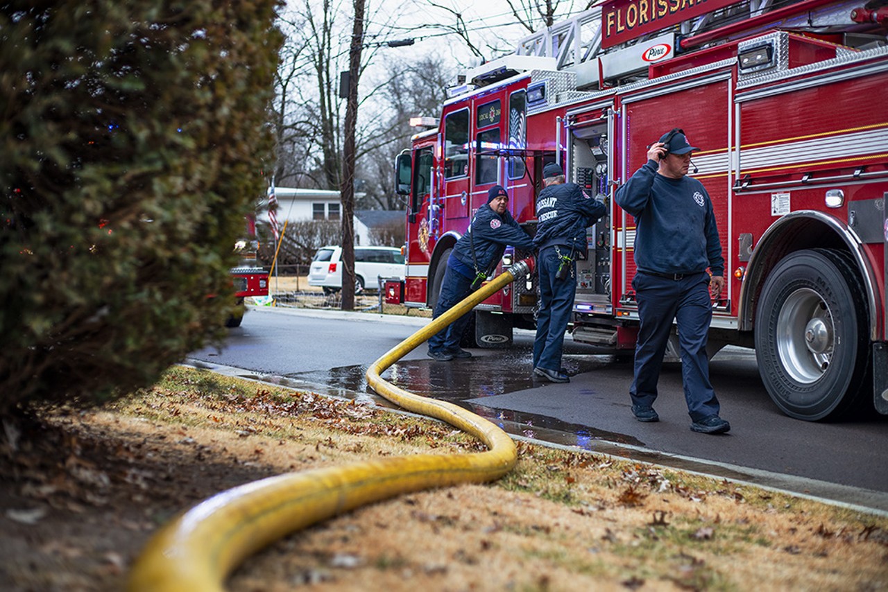 Firefighters with the Florissant Valley Fire Protection District attach a water hose to their truck on Friday, Jan. 26, 2024, in Florissant.