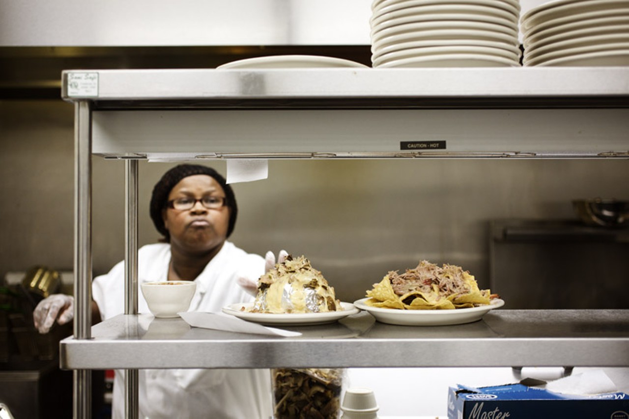 Tracei Dixon, kitchen manager at Flavors BBQ in the Grove, preparing the food.