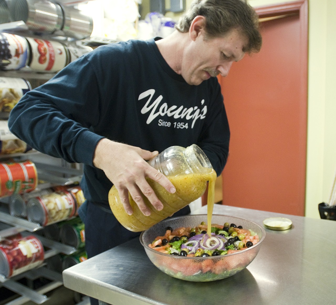 Here, Grant is preparing a large (for the catered event in back) house salad.
