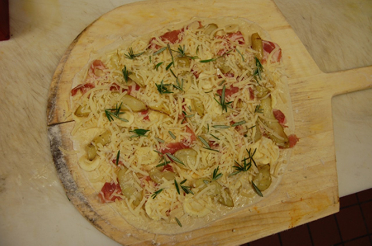 When completed, this pizza includes fingerling potatoes, parsnips, pancetta, parmiggiano, onion and rosemary.