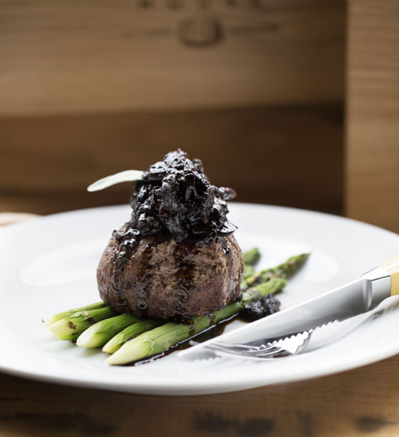 "Tete De Filet" is a grilled eight-ounce filet with balsamic sage glaze and wild mushrooms, served with grilled asparagus.