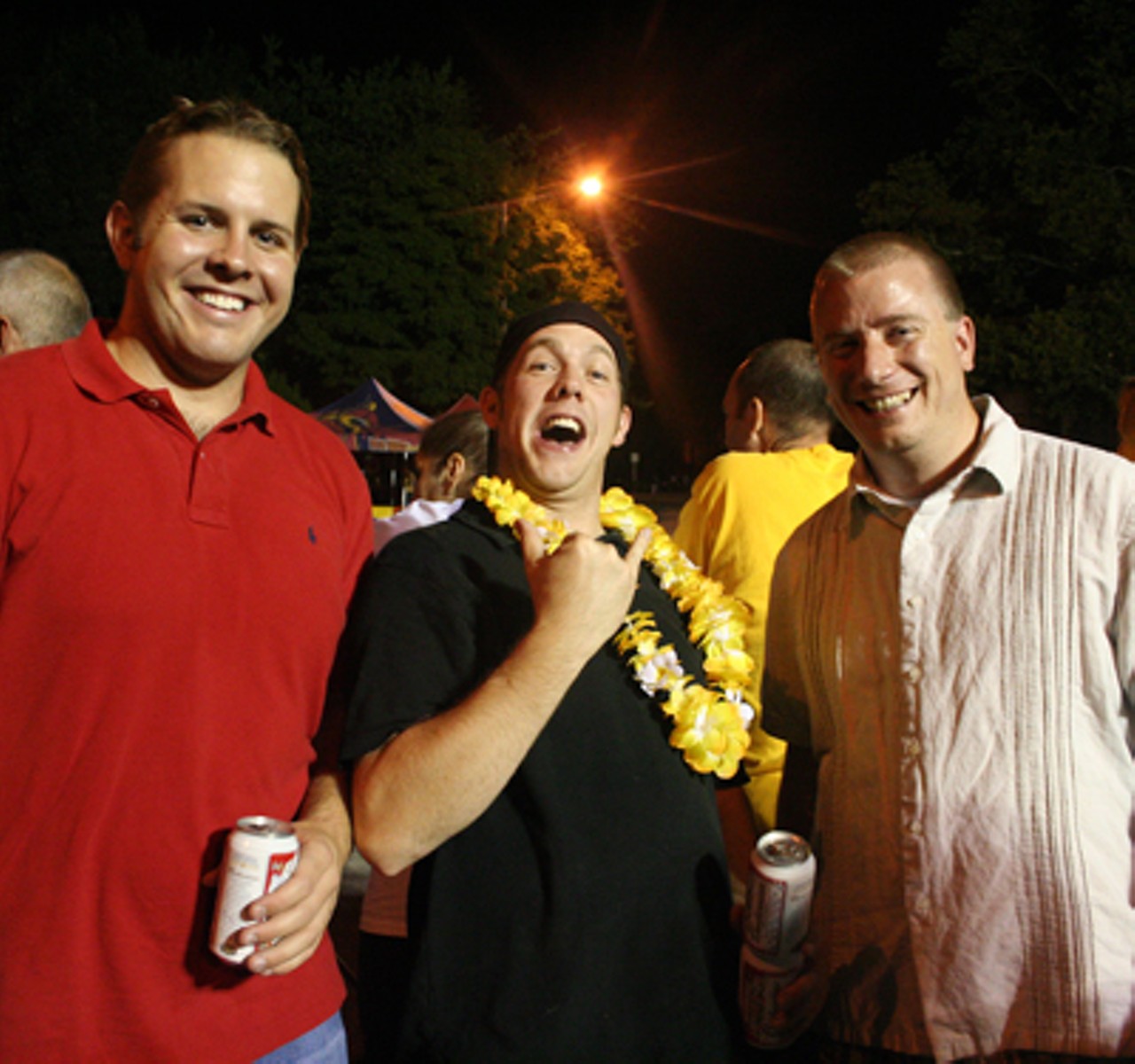 The guy in the middle was celebrating his bachelor's party with his buds and Bud at the races.
