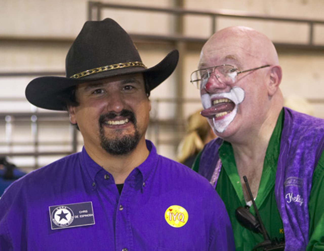 A rodeo clown protects the cowboys and cleans their ears.