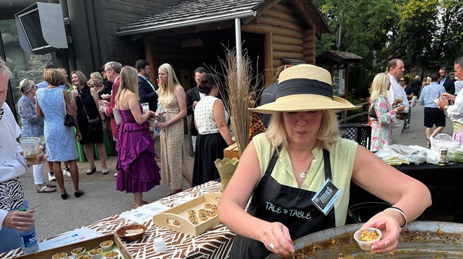 Kate Hannan of Tale to Table serves up some paella from a very giant pan.