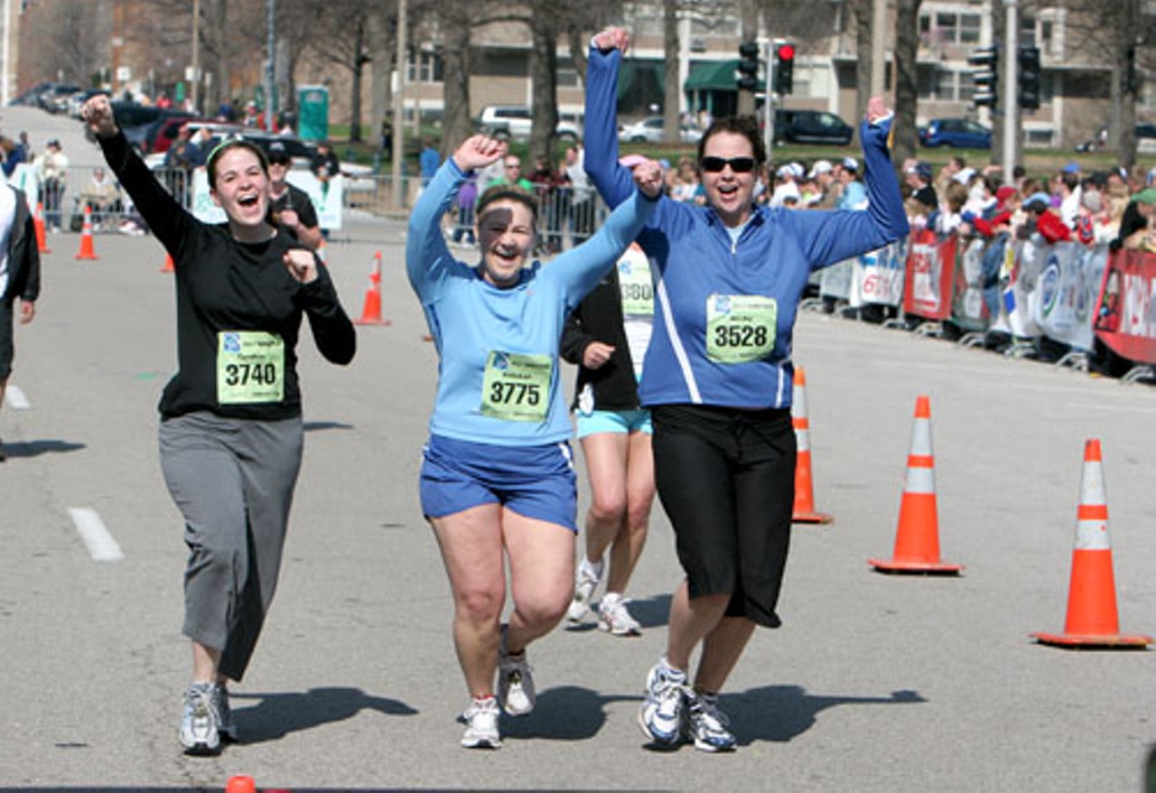 Cindy Halbrook, Bekah Emmons and Becky McCluer cheer as they cross the finish line.