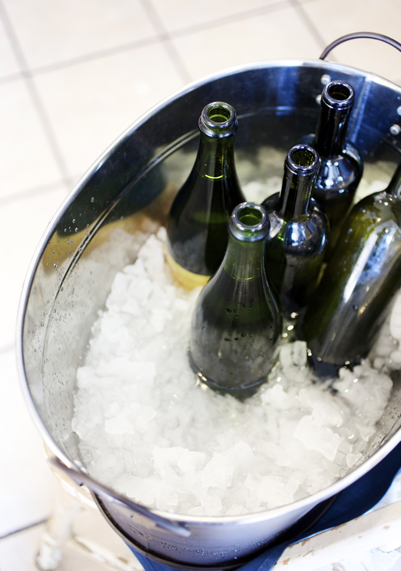 The bottles of water for table service in a rustic ice bucket near the entrance to the restaurant.