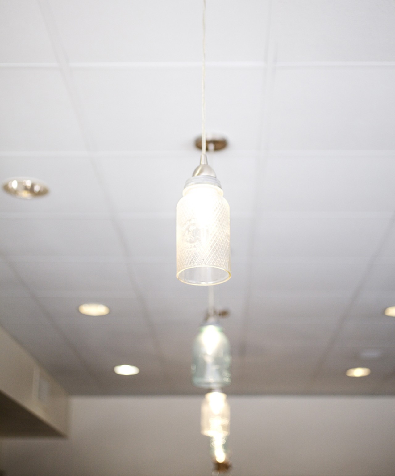 The pendants that hang above the bar are crafted with glass jars.