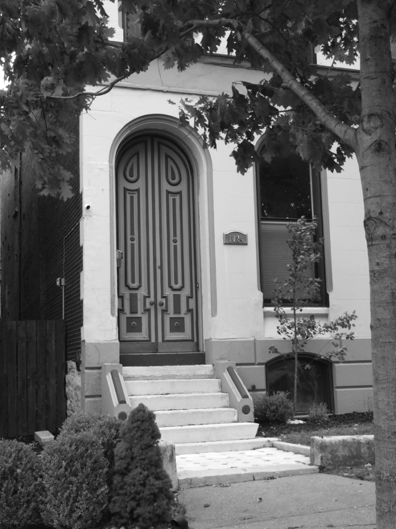 This Used to Be: Brewer Joseph Schnaider's townhouse turned Albanian Orthodox Church
Now It's: A private residence
Location: Lafayette Square
"Joseph Schnaider built this town house, along with others in the vacinity, in 1879," Harris writes. "The German-born brewer had operated the Schnaider Brewery on nearby Chouteau Avenue beginning in 1865. His beer garden, which covered the block opposite the town house on Mississippi, had achieved national fame. On summer evenings, thousands enjoyed the garden with its music pavillions, shade trees, flowers, and grottoes."
"The entrance to the Victorian home at 1024 Mississippi was once the entrance to a sanctuary." Image courtesy of NiNi Harris