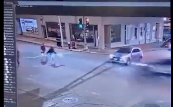 This screenshot shows the moments just before an SUV traveling at a high rate of speed T-bones another vehicle and then runs over two concert-goers.
