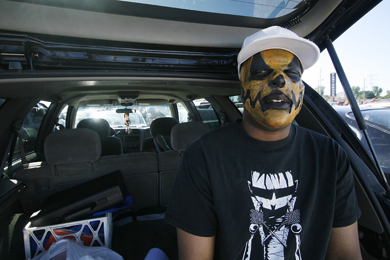 John Carr sits in the back of his car before the show. Carr said he's fallen off from ICP lately because the group is trying to be too mainstream. However, he said he still enjoys the group and getting sprayed with ice cold Faygo.