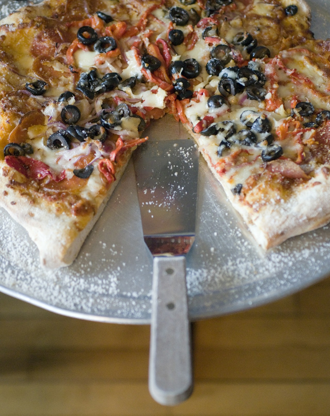 The pizza supreme is made with mozzarella cheese, black olives, roasted peppers, red onions and pepperoni.