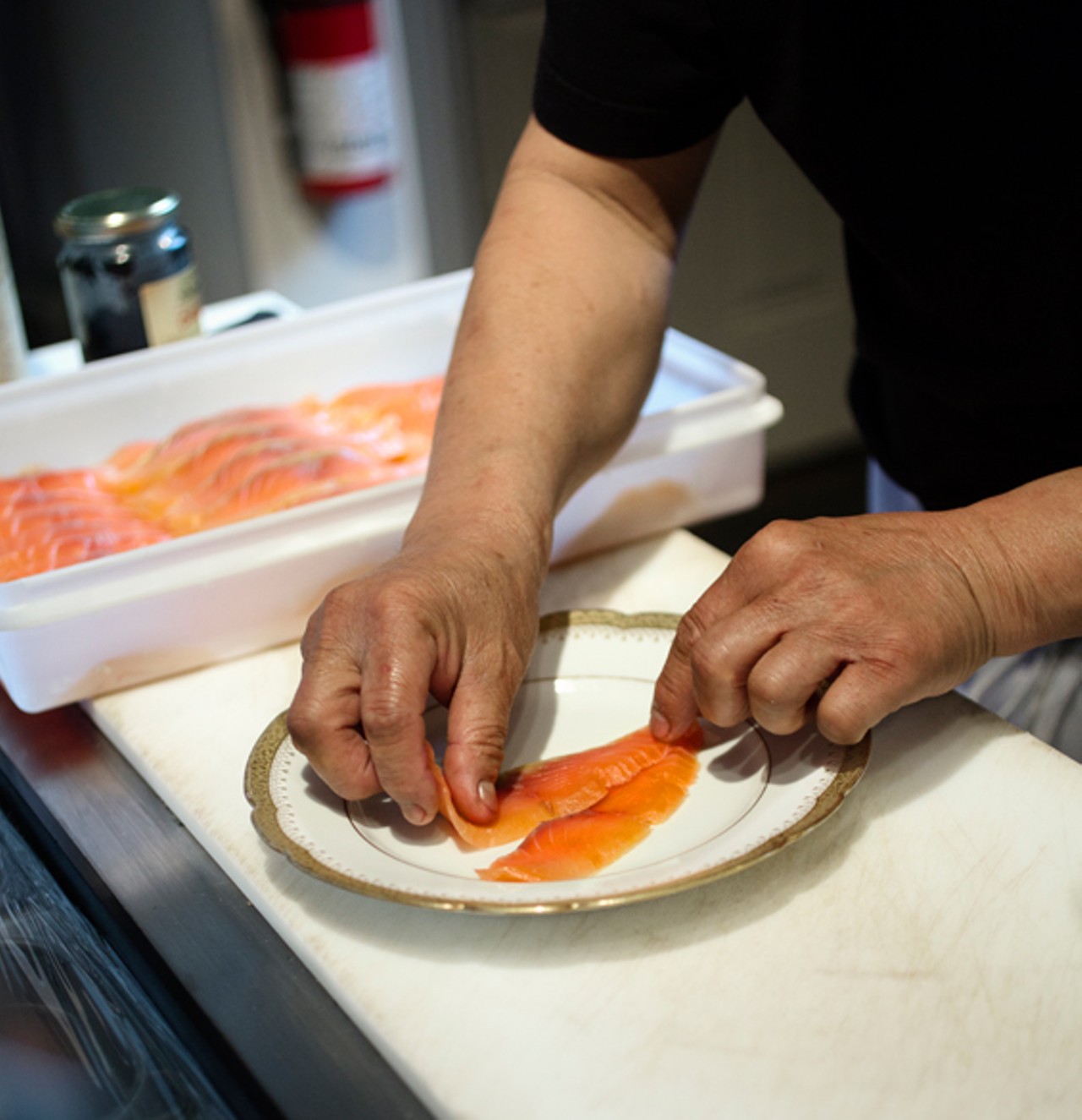 Exec chef Ny Vongsaly preparing the cured salmon.