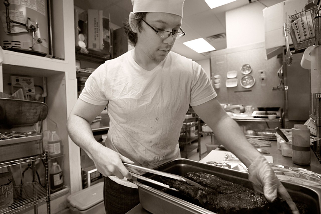 ASAP cook Drew Scott prepares to cut a rack of ribs.