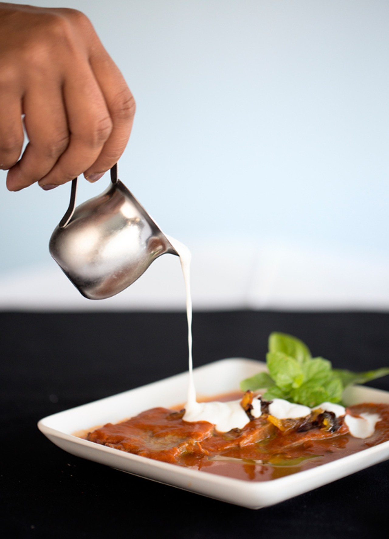 The beef tongue is served sliced in a buttery broth, with curry mustard sauce and yogurt.