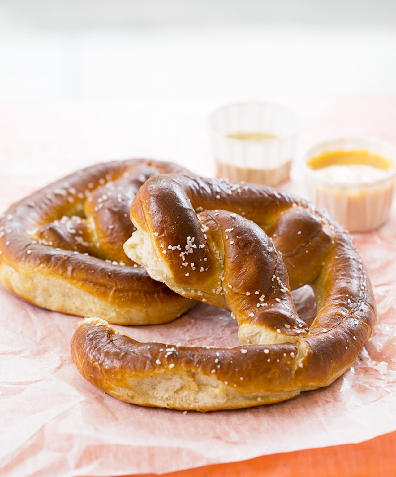 Two big soft pretzels. Buttered, salted, and toasted with dipping sauces.