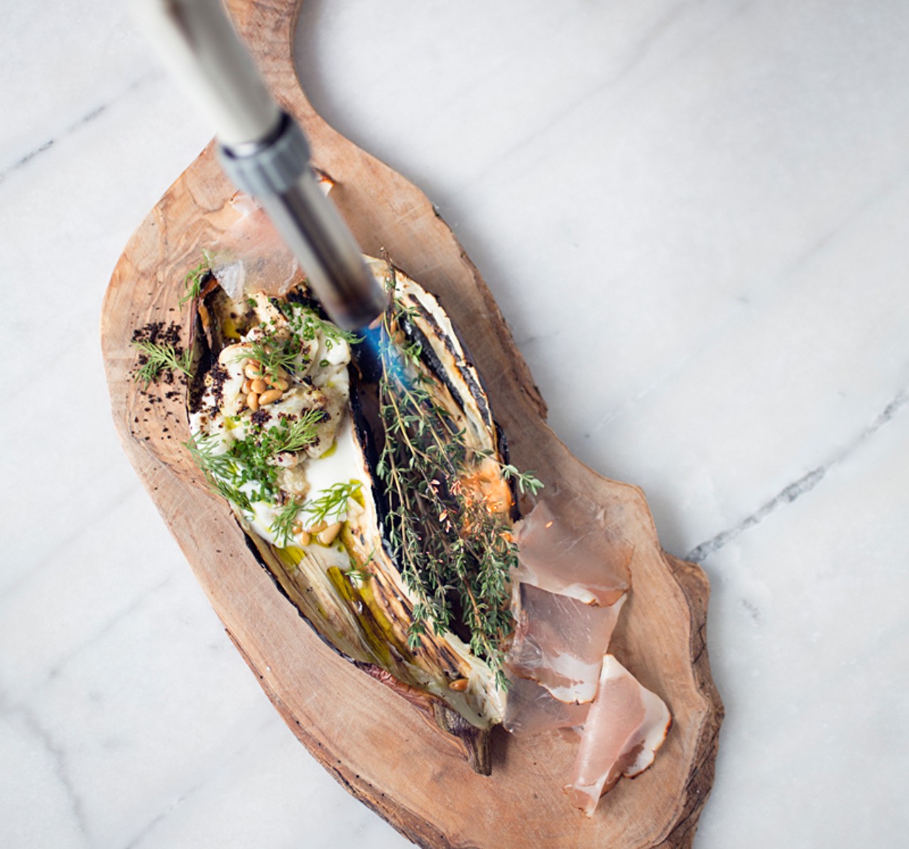 At Elaia - Charred eggplant, labneh, pinenuts, lonza, dill. Kitchen torch lighting the thyme.