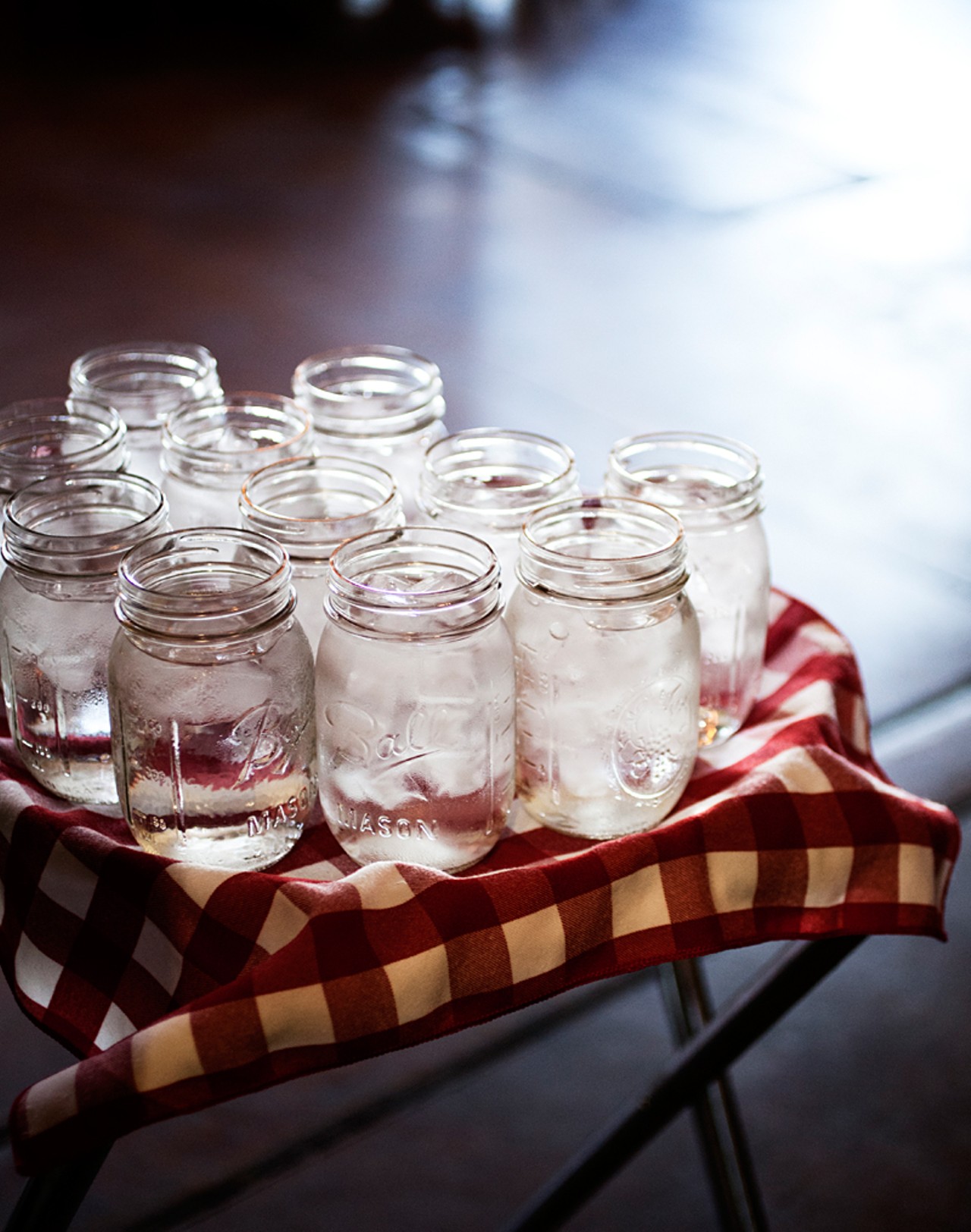 Mason jar water glasses ready to go to restaurant patrons.