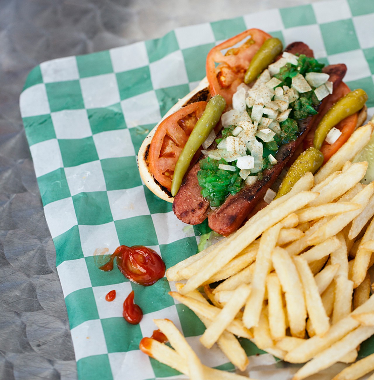 The "Downtown Dog" is topped with relish, onions, peppers, pickle, tomato and celery salt.