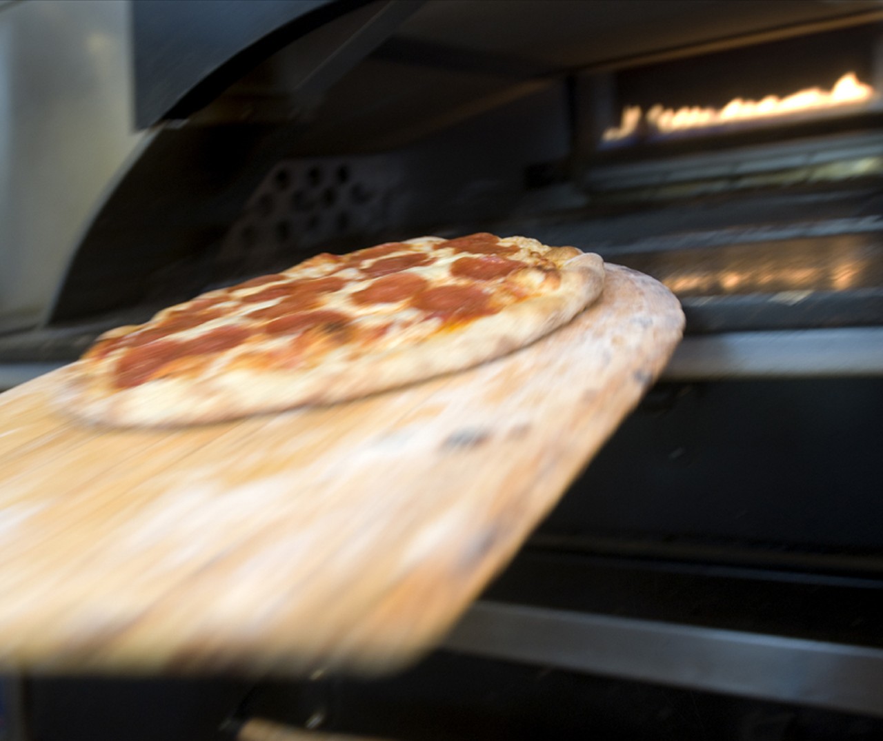 The pepperoni pizza makes its way from the lower oven to the top oven for the final browning effect.