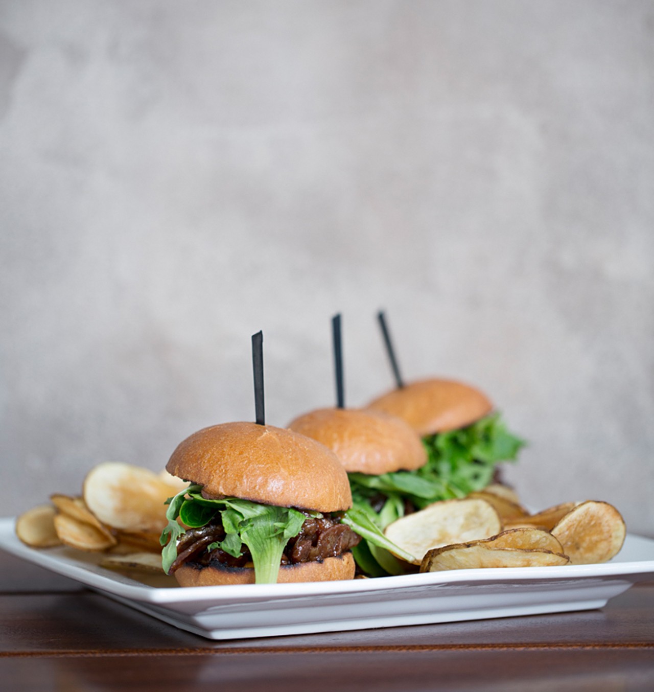Bulgogi sliders are served on brioche buns with greens and a spicy mayo.