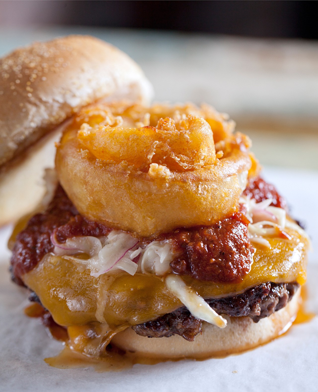 The "Smokehouse Smash Burger" is served with bbq, bacon jam, onion ring, carolina slaw and cheddar cheese.