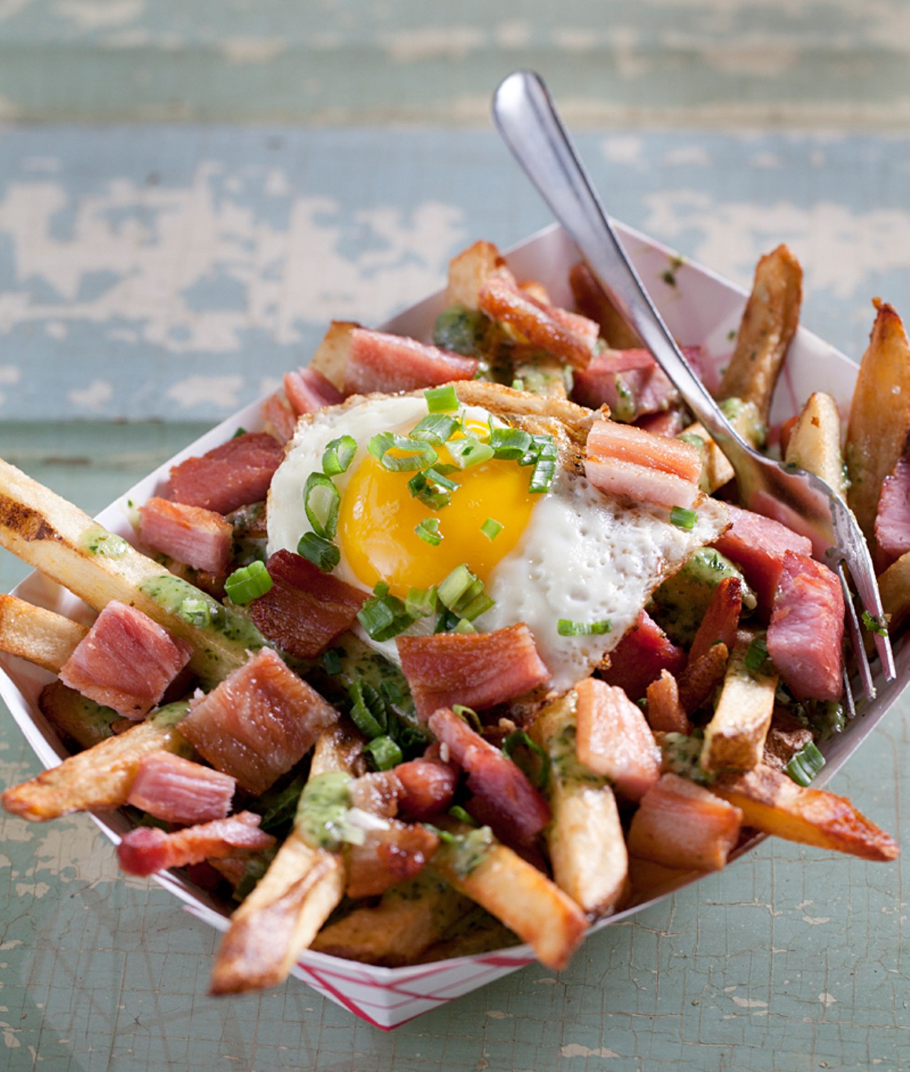 One of the menu's "Boardwalk Fries," the "Green Eggs N Ham" is fresh cut Idaho russett potatoes tossed in sea salt, a fried egg, diced ham, creamed spinach, and green onion.