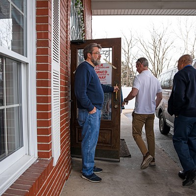 The church building's former owner, Reverend Arlie Singleton, left, holds the door while code enforcers with the City of St. Louis enter Mount Of Olives Ministry on Tuesday, March 5, 2024.