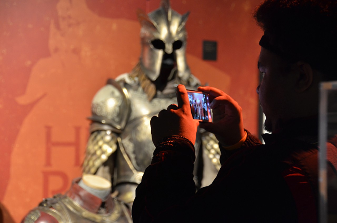 A fan photographs the Lannister costumes.