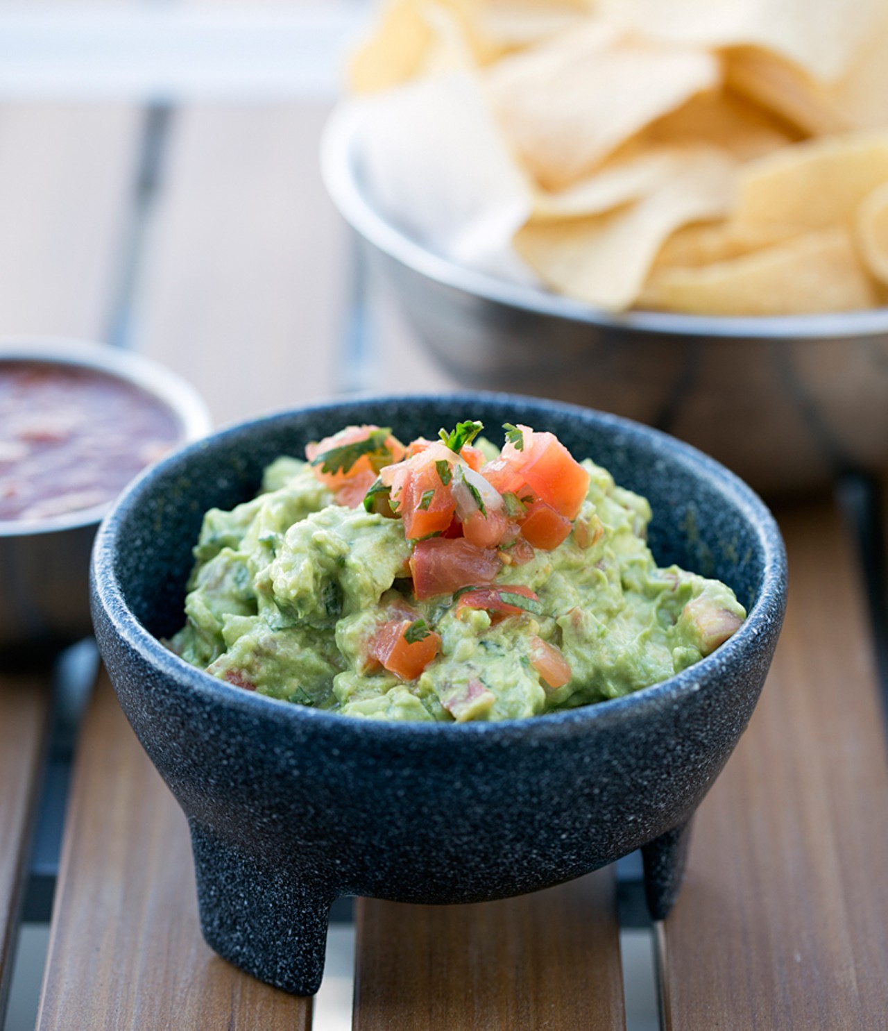 Vida's handcrafted guac with chips and salsa.