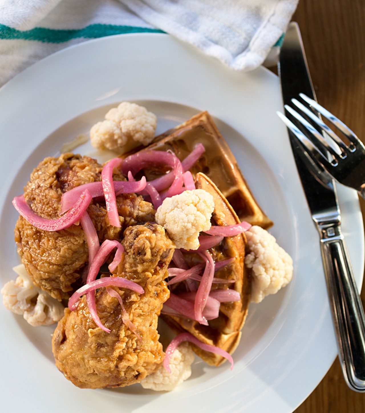 Juniper&rsquo;s chicken & waffles come with pickles, syrup and peanut butter.