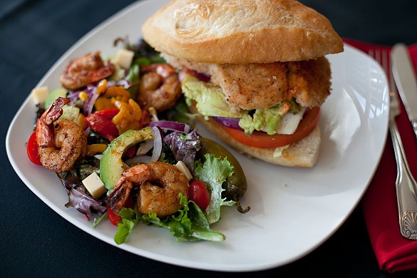 The Chicken Torta with chipotle aioli served with a house salad and shrimp with cilantro dressing.