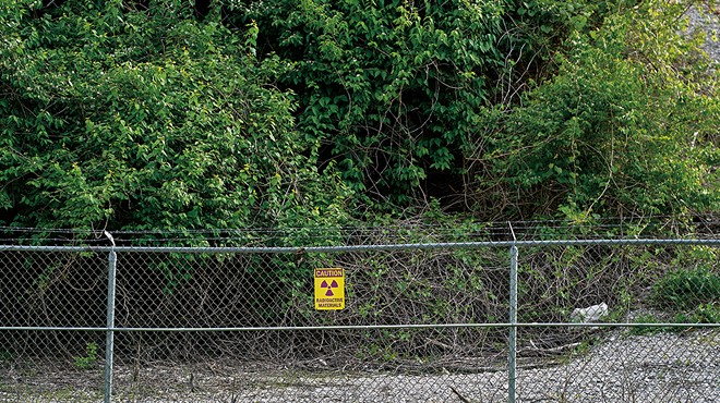 A sign warns of radioactive material at the West Lake Landfill. Thousands of tons of nuclear waste from the Manhattan Project were dumped there in the 1970s.