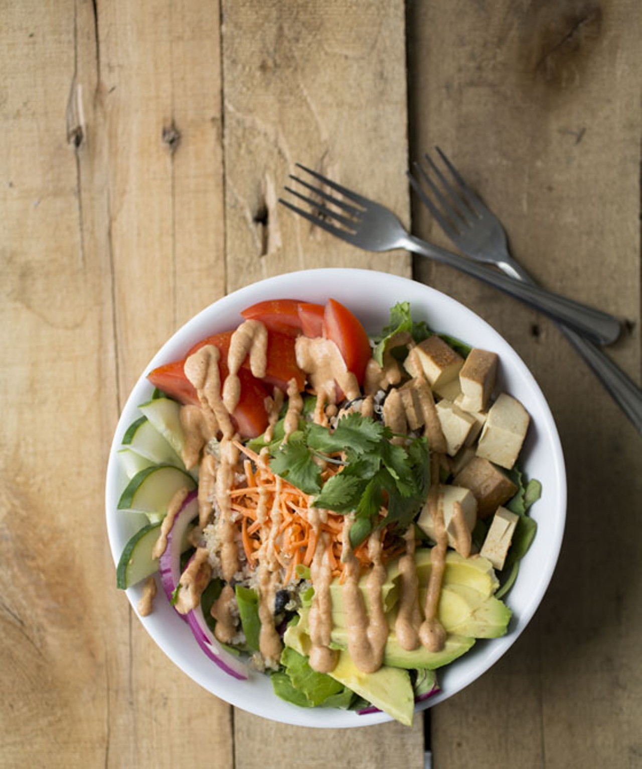 The "Power Protein Bowl" is a quinoa salad with organic marinated tofu, greens, cucumber, red onion, shredded carrot, tomato and fresh avocado with spicy chipotle sauce.