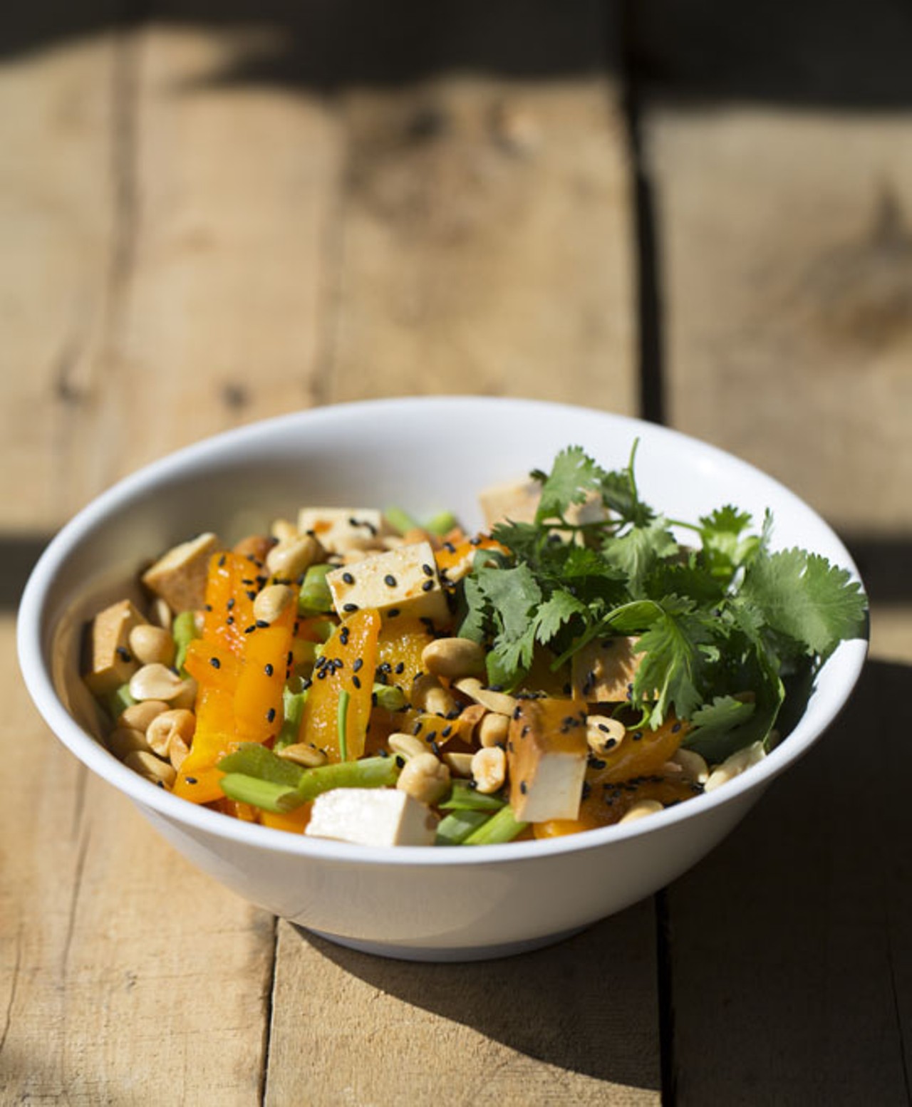 The "Buddha Bowl" is brimming with udon noodles, organic marinated tofu, stir-fried vegetables, green onion, cilantro, crushed peanuts, black sesame seeds and homemade peanut sauce.