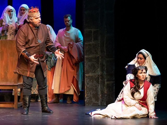 Macbeth (Michael Eugene Nansel, standing left) and Lady Macbeth (Whitney Myers, seated in the foreground) set off a murder spree in Macbeth.