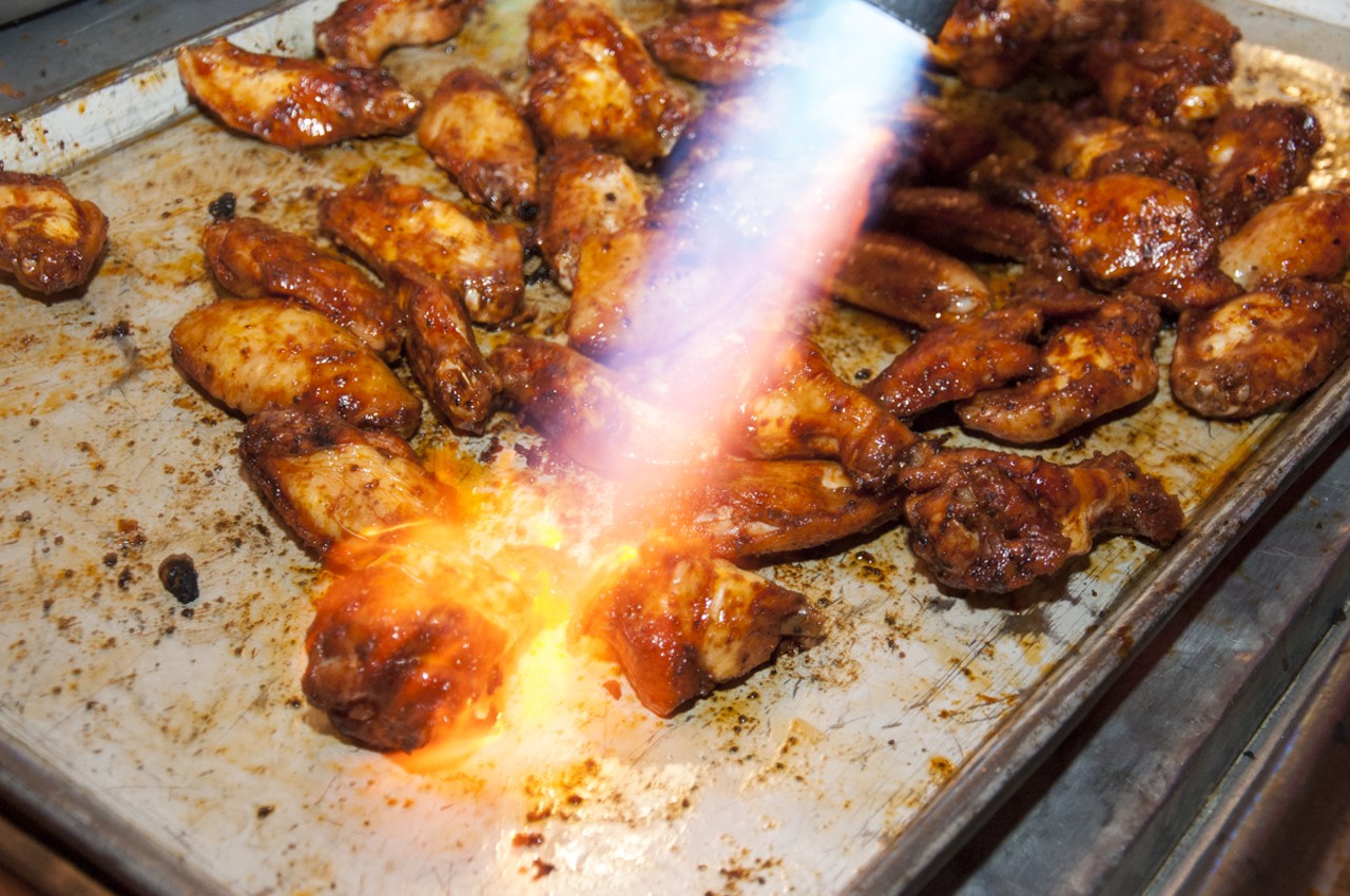 Cranberry Cayenne Wings from Bogarts smokehouse being flame charred to perfection. Slightly sweet and spicy.