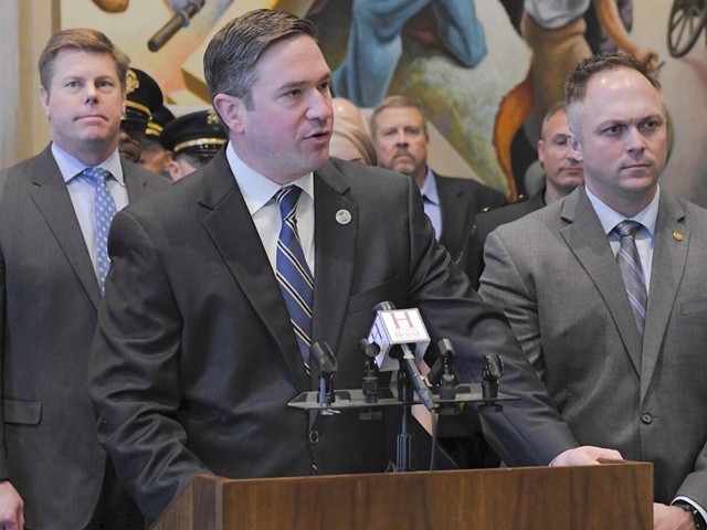 Attorney General Andrew Bailey speaks at a press conference in the Missouri House Lounge, flanked by House Speaker Dean Plocher, left, and state Rep. Justin Sparks.