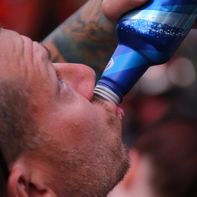 A man drinks Bud Light.