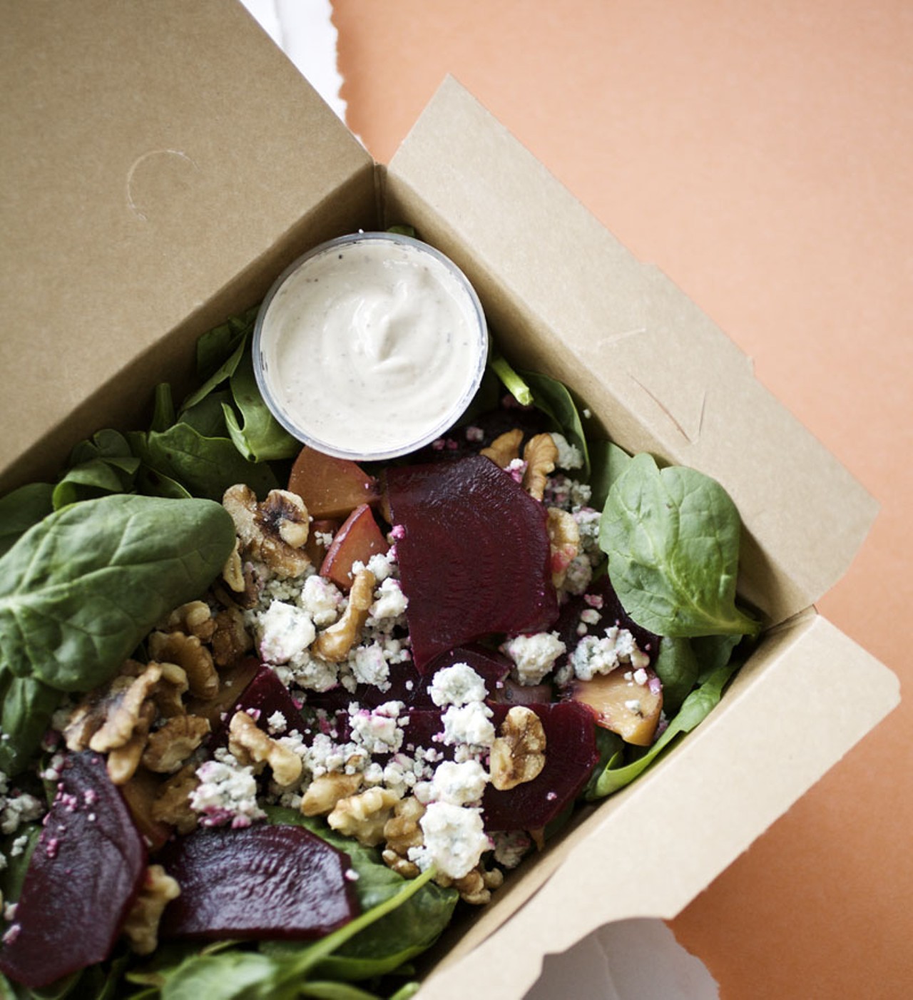 The Just Beet It salad is made with salted roasted beets, oven dried peaches, blue cheese crumbles, toasted walnuts & baby spinach with a sherry-walnut vinaigrette.