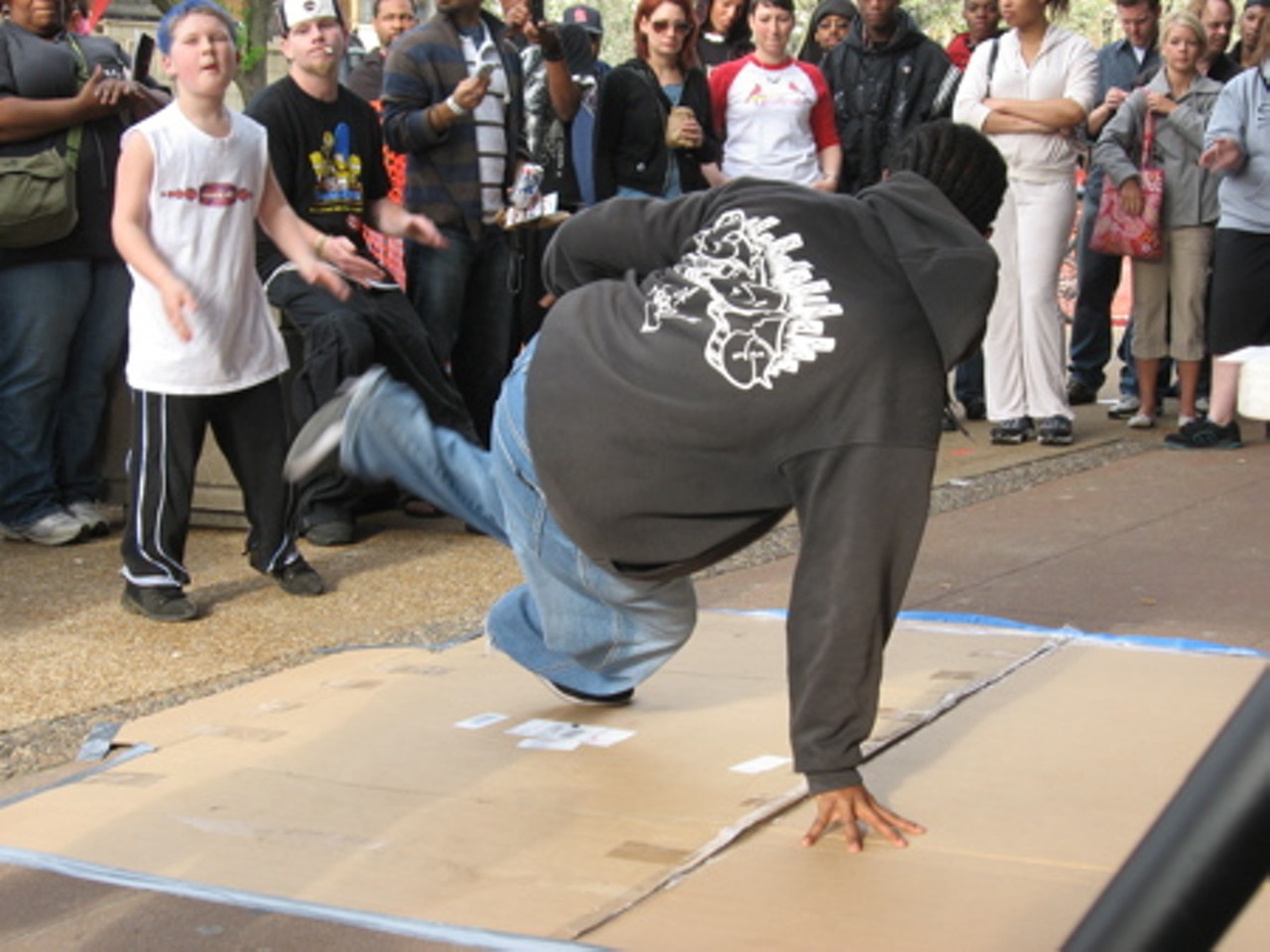 B-Boys lay down the cardboard and give a little performance.