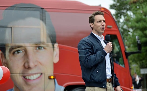 Josh Hawley in front of a large photo of Josh Hawley.