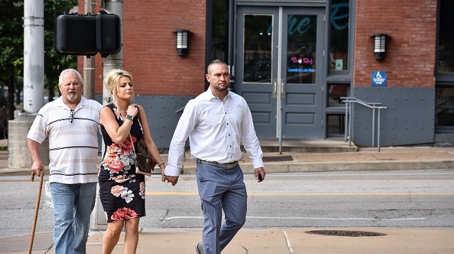 Dustin Boone, right, walks to the federal courthouse in St. Louis with his family.