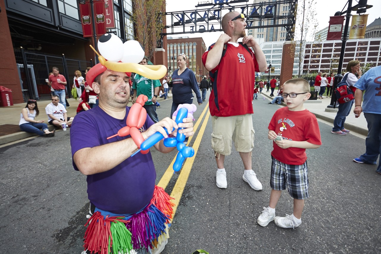 Joe the Balloon Man crafts animals and hats for young Cardinals fans.