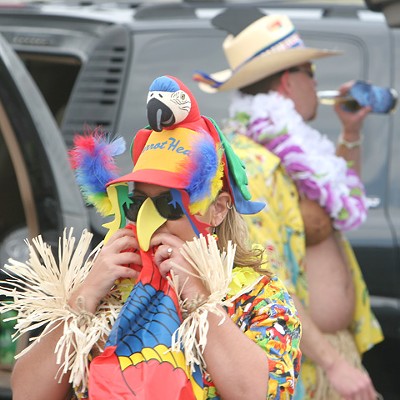 A true parrothead, Sheli Sutherland, inflates a parrot. Sheli and her husband, Todd, decorated their vehicle with inflatables.