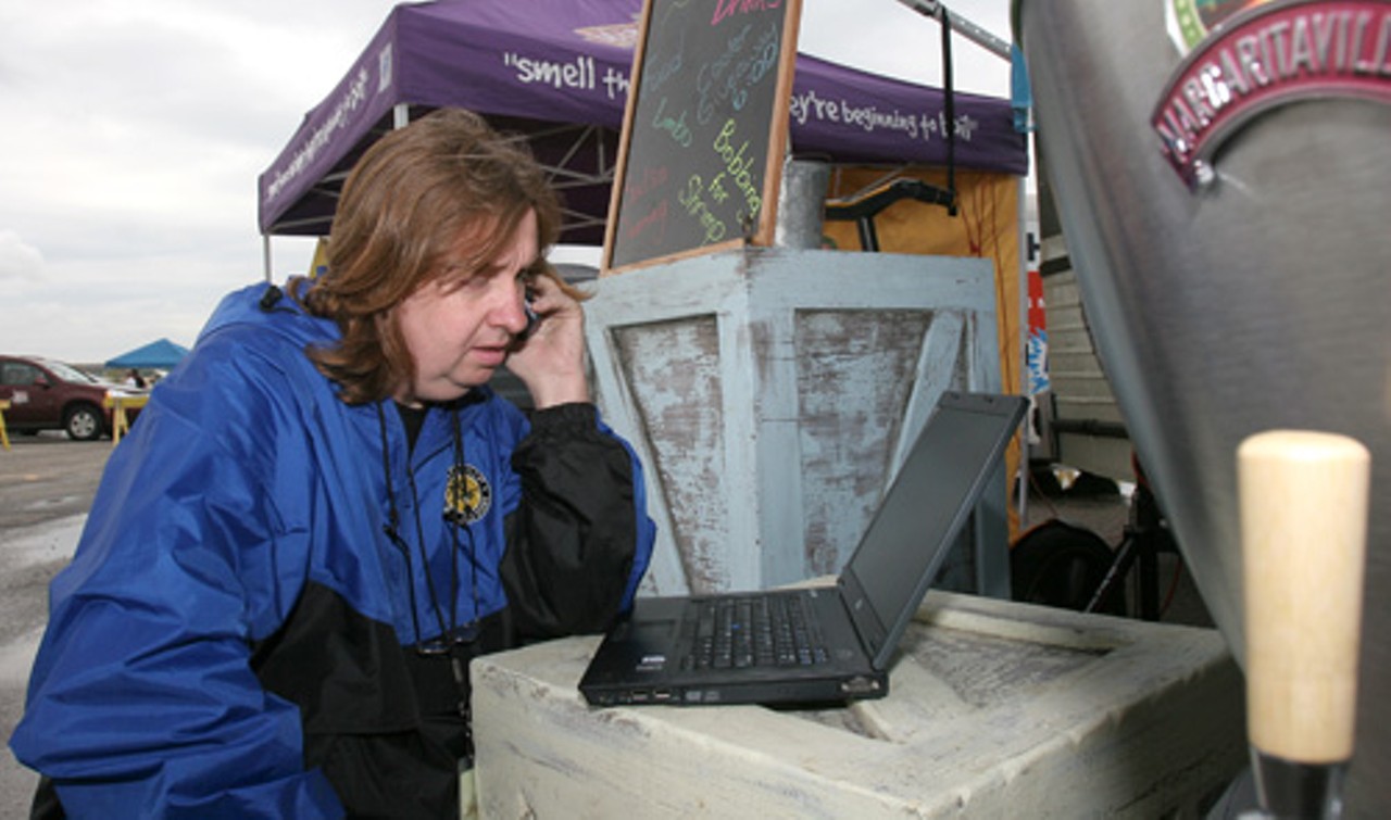 Paul Morgan, tour manager of Jimmy Buffett&rsquo;s Margaritaville Express, takes care of his daily duties before the parking lot opens to the public. Morgan usually speaks with upcoming venue representatives, double checks hotel reservations, and ''make sure our ducks are in a row.'' He uses the computer outside the bus due to a better internet connection.