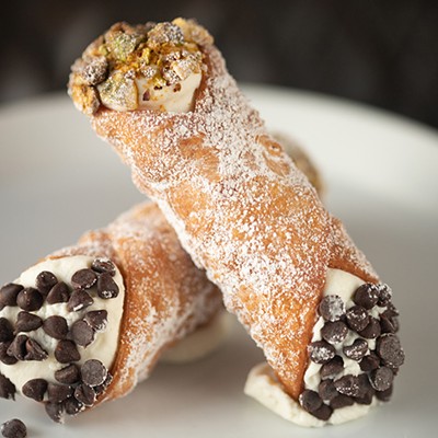 Cannoli with traditional Sicilian sweet ricotta filling, chocolate and pistachio.