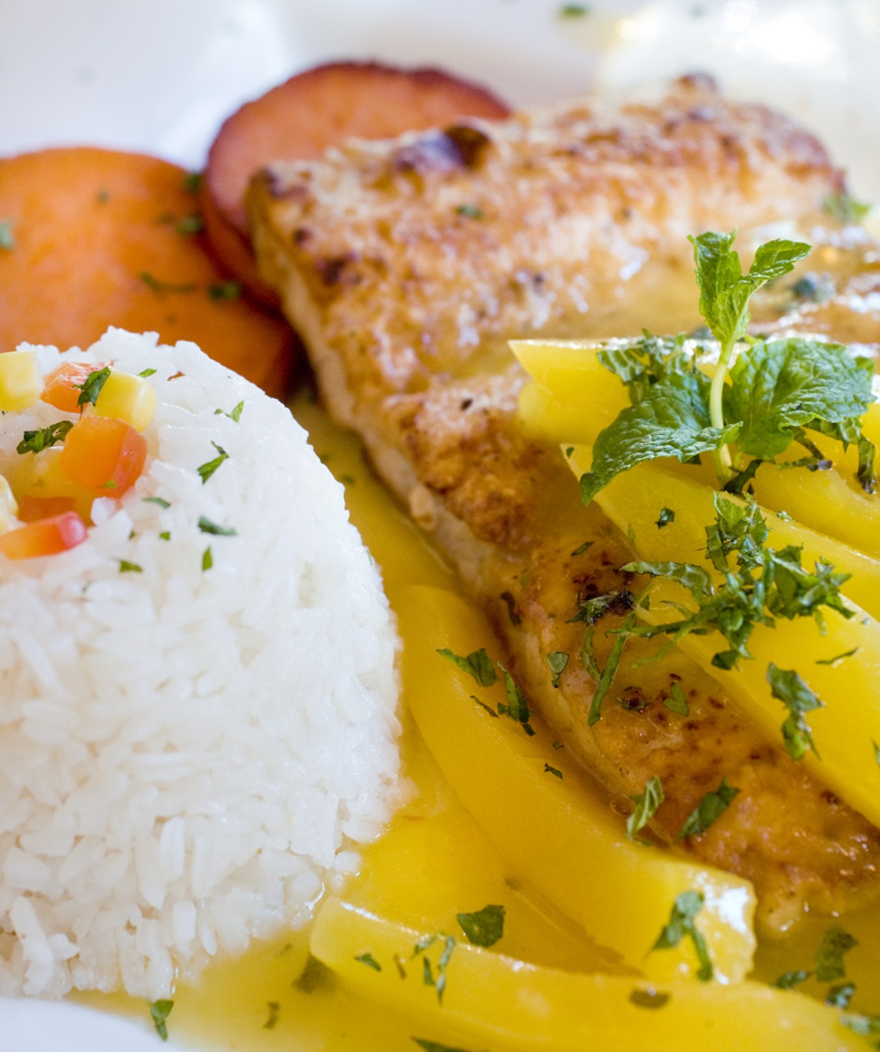 A special, the pescado apasionado, or the passionate fish. A fillet of Mahi-Mahi is saut&eacute;ed and topped with a mango and passion fruit sauce. It is then served with rice and golden sweet potatoes.