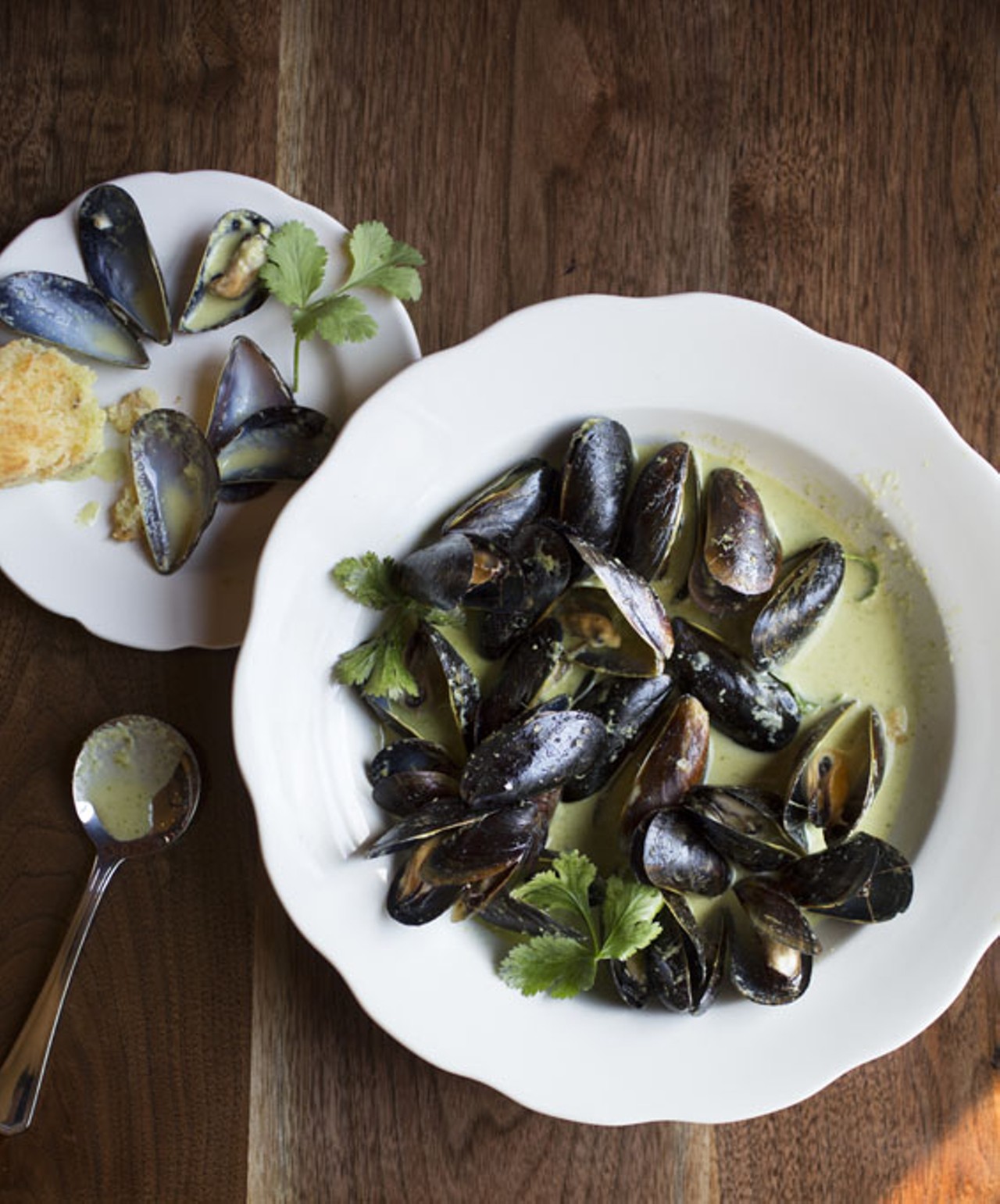 The mussel stew, served with cornbread, is sauteed in a green curry-coconut milk sauce.