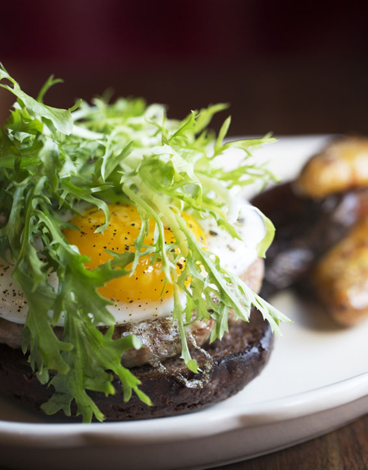 The duck burger is topped with Gouda, a fried duck egg and frisee that's tossed in vinaigrette and served open-face on a pumpernickel bun. Smashed and fried fingerlind potatoes come on the side.